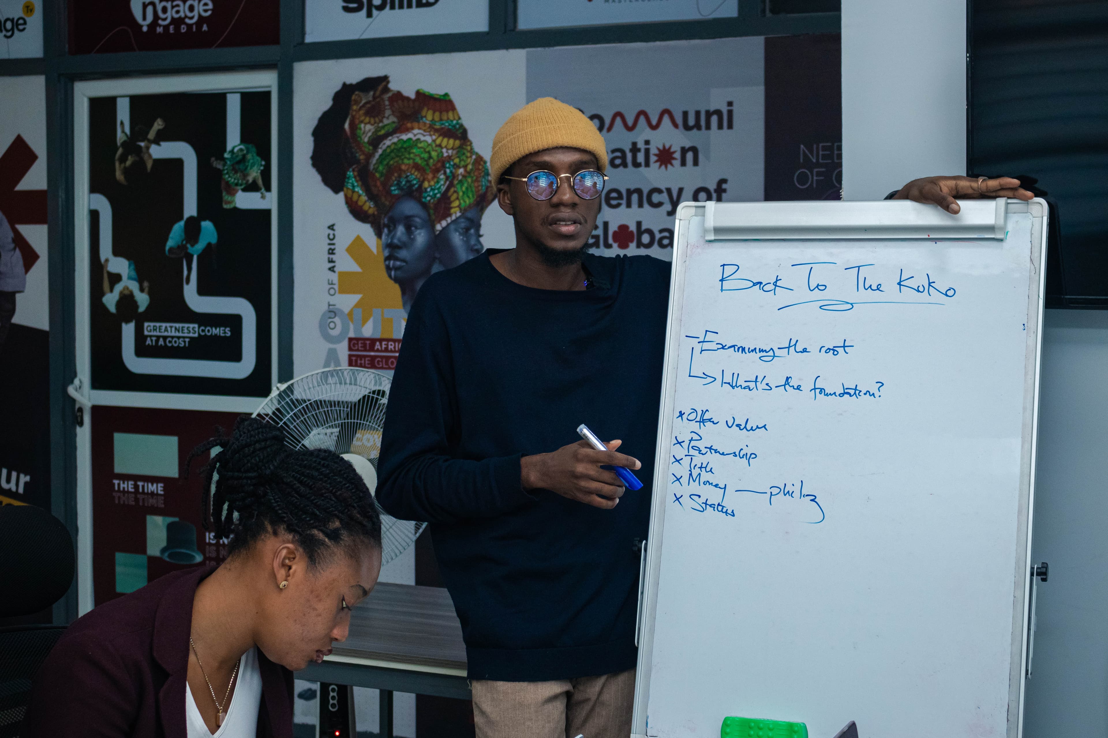 Leading a workshop session at the whiteboard with the team